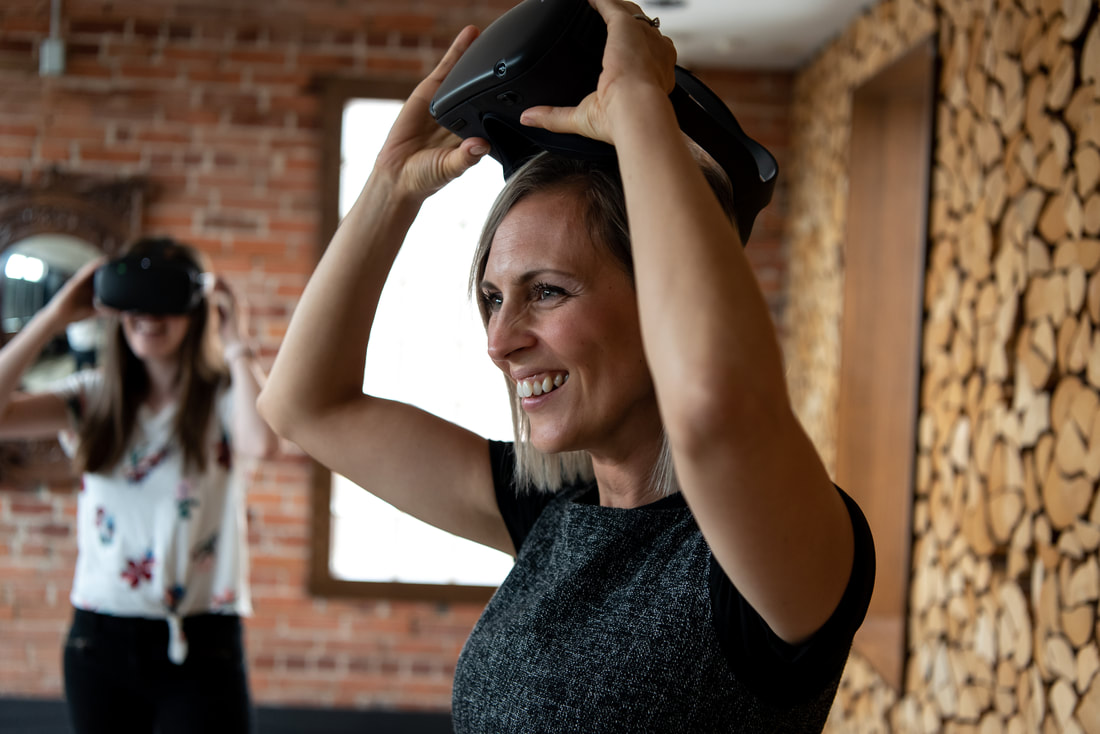 Photo of a woman taking off a VR headset